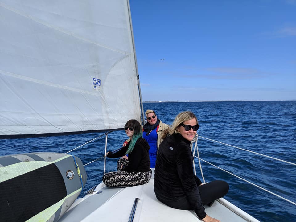 Sara Newton and friends on a sailboat.