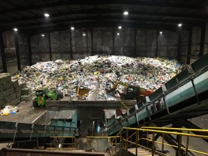 Plastic sorting facility with tons of plastics piled up and ready for separation